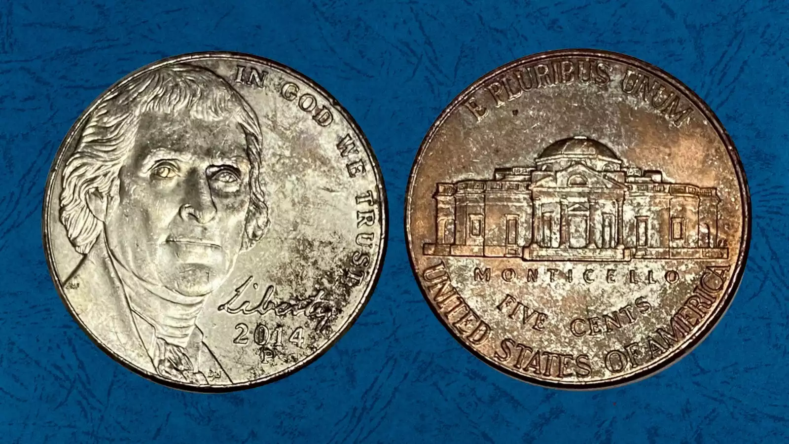 2014 Jefferson nickel missing clad layer error showing exposed copper-red surface